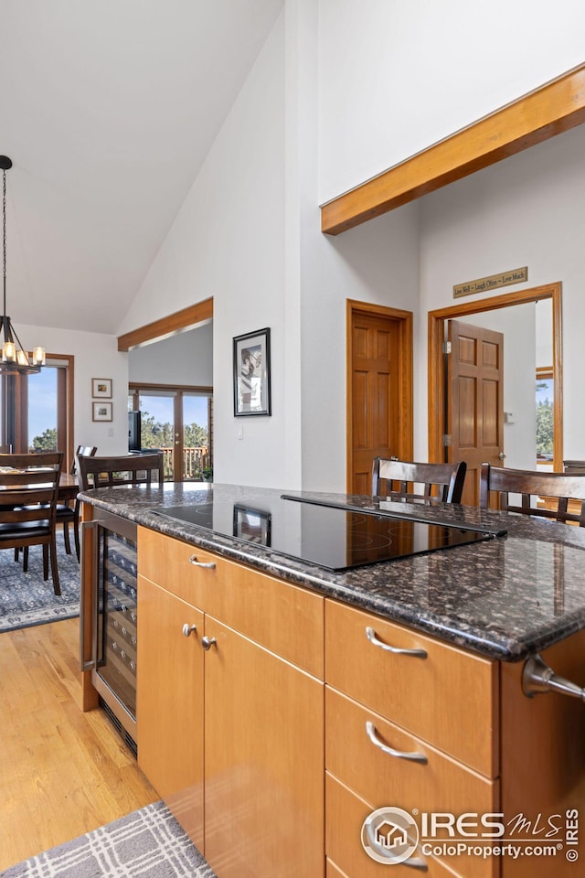 kitchen with a warming drawer, a sink, a kitchen breakfast bar, stainless steel appliances, and light wood finished floors