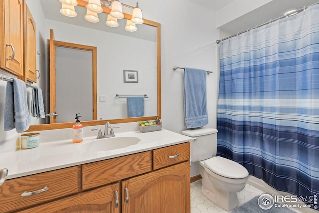 bathroom featuring tile patterned floors, toilet, vanity, and a shower with curtain