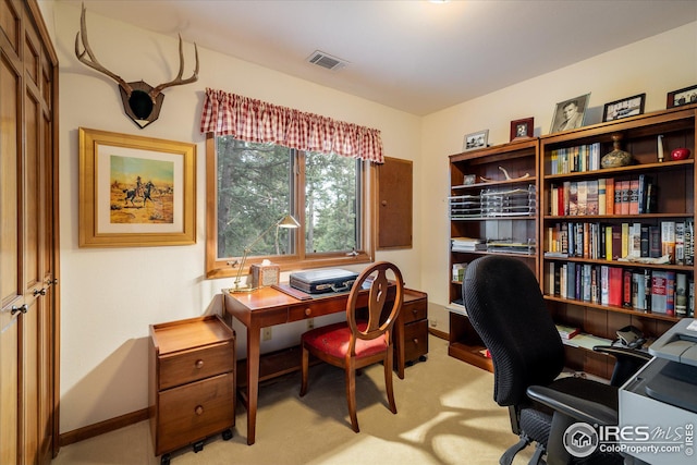 office area with light colored carpet, visible vents, and baseboards