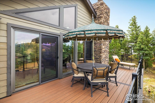 wooden terrace with outdoor dining area