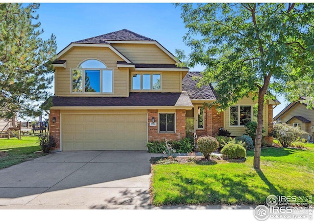 craftsman house featuring brick siding, a shingled roof, a front yard, driveway, and an attached garage