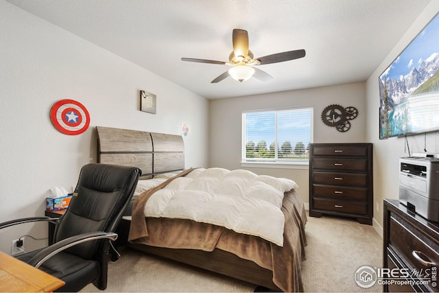 bedroom featuring light colored carpet, baseboards, and a ceiling fan