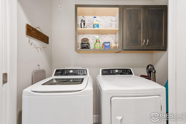 laundry area featuring washer and dryer and cabinet space