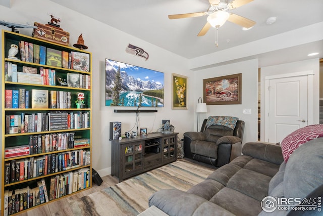 living room with wood finished floors and a ceiling fan