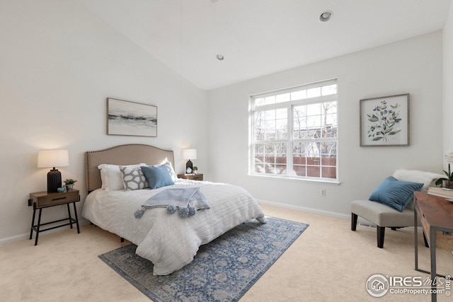 bedroom featuring lofted ceiling, baseboards, and light carpet