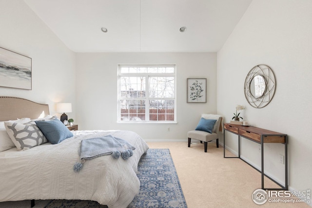 bedroom featuring baseboards, carpet, and vaulted ceiling