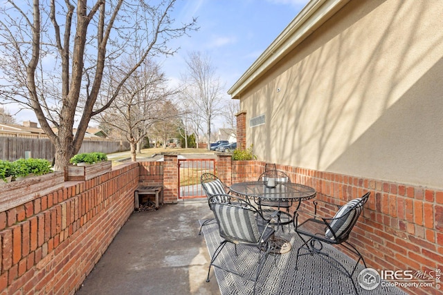 view of patio / terrace with outdoor dining space and fence