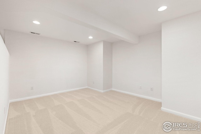 spare room with baseboards, recessed lighting, visible vents, and light carpet