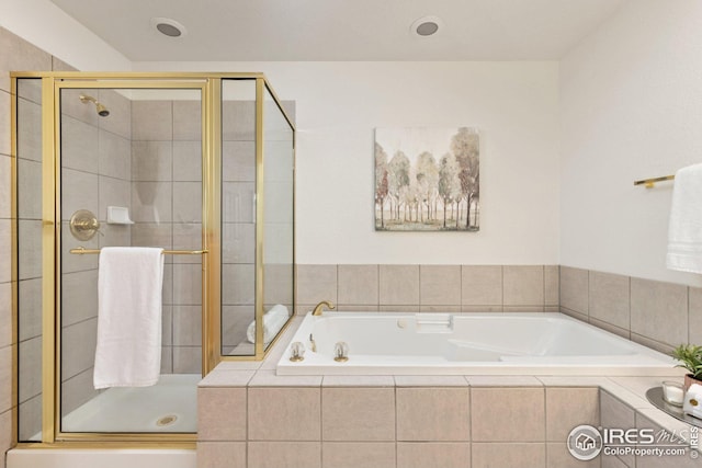 full bathroom with a shower stall and a garden tub