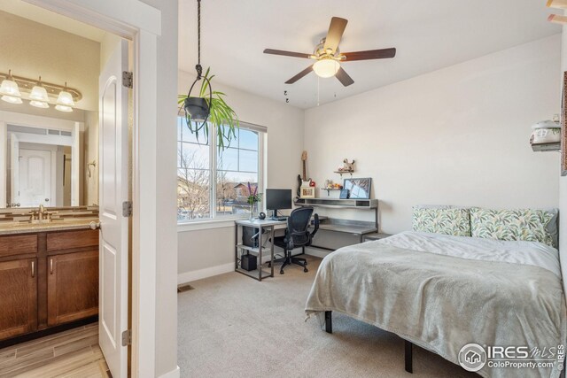 2556 Des Moines Dr Unit 103, Fort Collins, CO 80525 - bedroom featuring visible vents, ceiling fan, baseboards, light carpet, and a sink