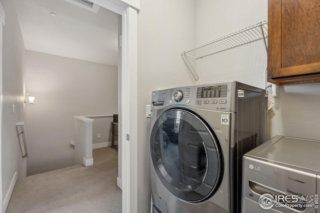 2556 Des Moines Dr Unit 103, Fort Collins, CO 80525 - laundry area with baseboards, cabinet space, light carpet, and washing machine and dryer
