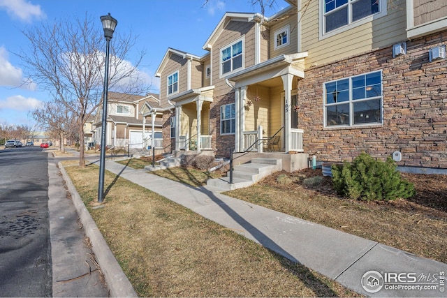 view of front of property with a residential view and stone siding