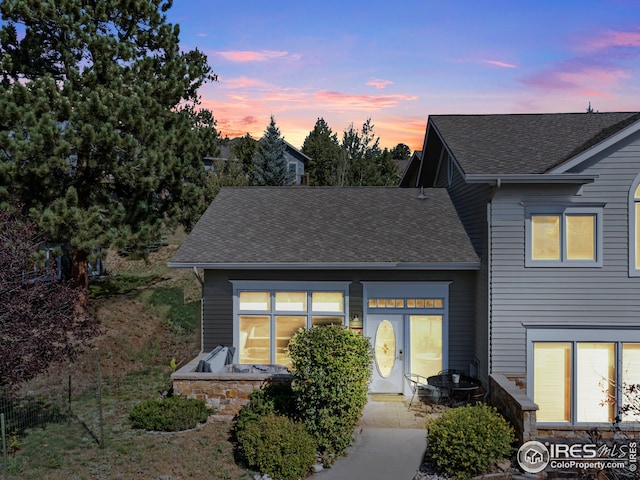 321 Overlook Ln, Estes Park, CO 80517 - exterior entry at dusk featuring a shingled roof