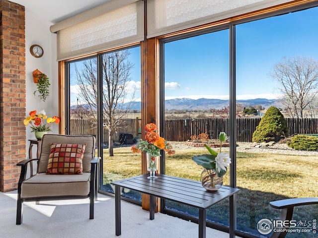 sunroom / solarium featuring a mountain view