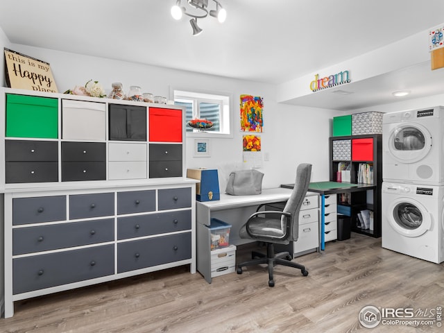 office with stacked washer / drying machine and wood finished floors