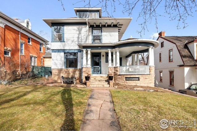 view of front of home featuring brick siding, covered porch, and a front yard