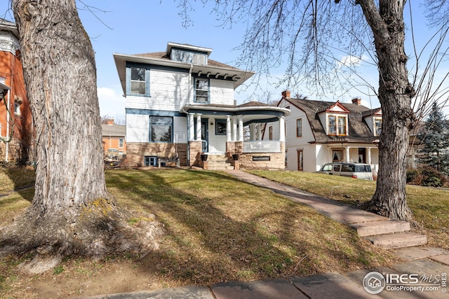 traditional style home with a porch and a front yard