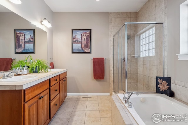 full bath featuring a stall shower, a sink, double vanity, baseboards, and a bath