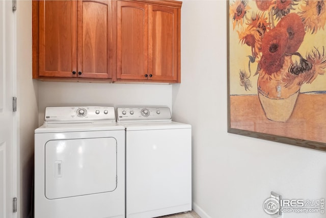 laundry room with washer and dryer and cabinet space
