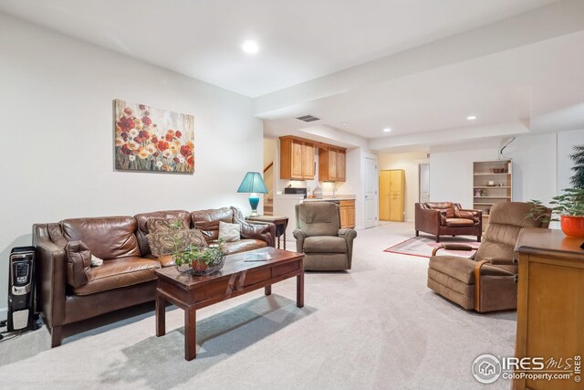 living area with recessed lighting, light colored carpet, and visible vents