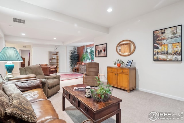 living room with recessed lighting, visible vents, baseboards, and light colored carpet