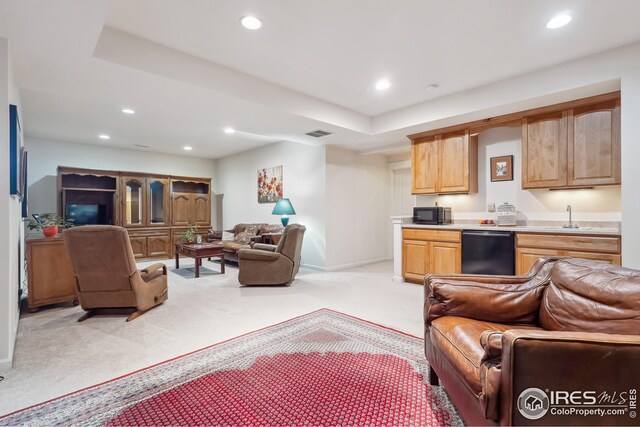 living room with recessed lighting, visible vents, and light colored carpet