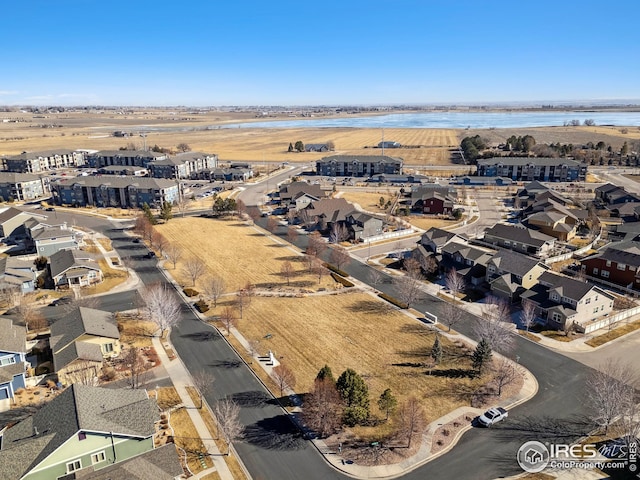 drone / aerial view featuring a residential view and a water view