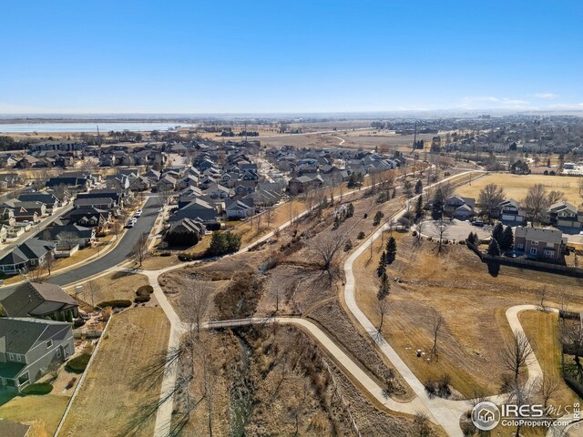drone / aerial view with a residential view and a water view