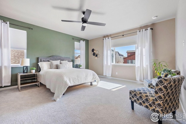 carpeted bedroom with a ceiling fan and baseboards