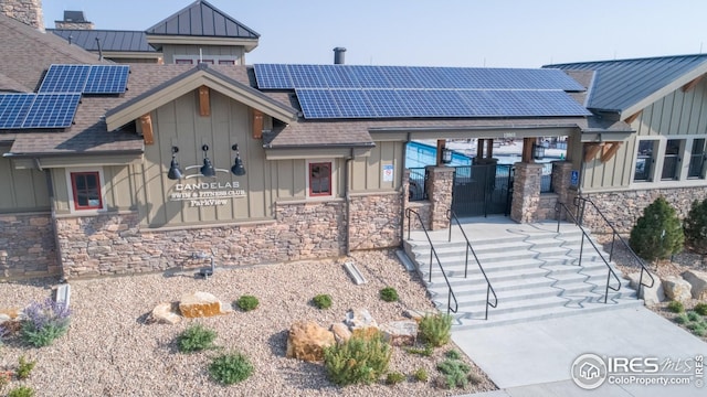 view of front of property with stone siding and board and batten siding
