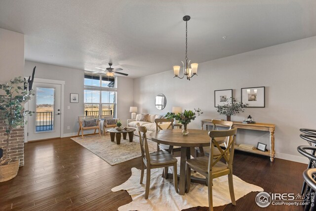 dining space featuring baseboards, wood finished floors, and ceiling fan with notable chandelier