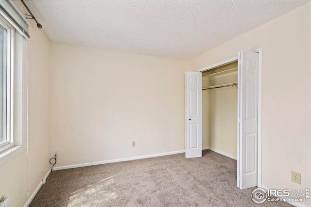 walk in closet featuring dark colored carpet