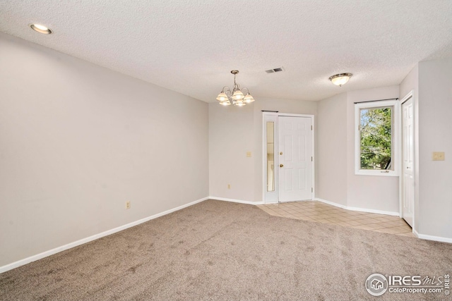 carpeted living area with a tiled fireplace, recessed lighting, and a textured ceiling