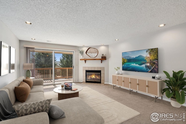 unfurnished living room featuring a textured ceiling, carpet flooring, baseboards, recessed lighting, and a fireplace