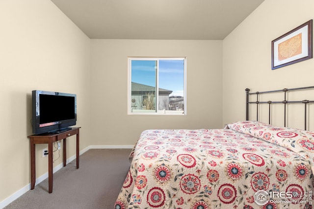 carpeted bedroom featuring baseboards