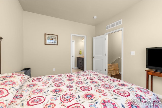 bedroom featuring visible vents and ensuite bath