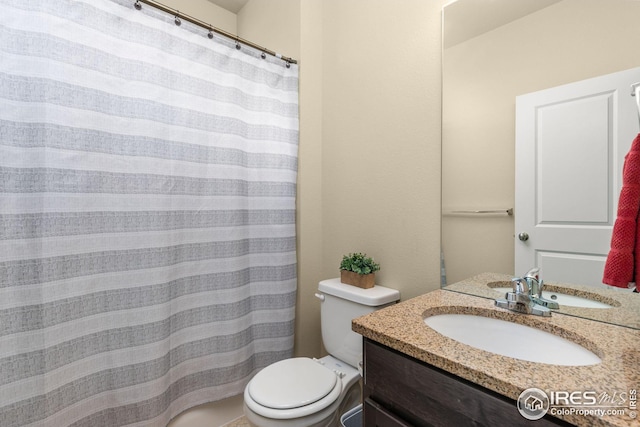 bathroom with toilet and vanity