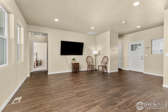 unfurnished living room featuring recessed lighting, wood finished floors, and visible vents