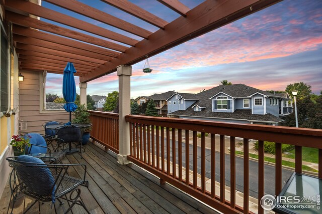 wooden terrace featuring a residential view and a pergola