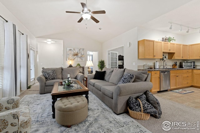 living area featuring vaulted ceiling, light carpet, a toaster, and ceiling fan