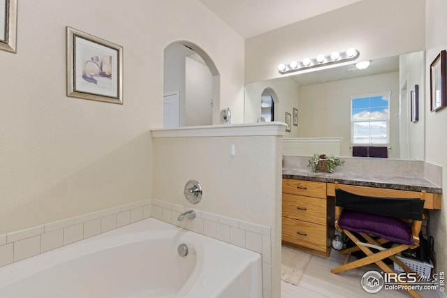 bathroom featuring vanity and a garden tub