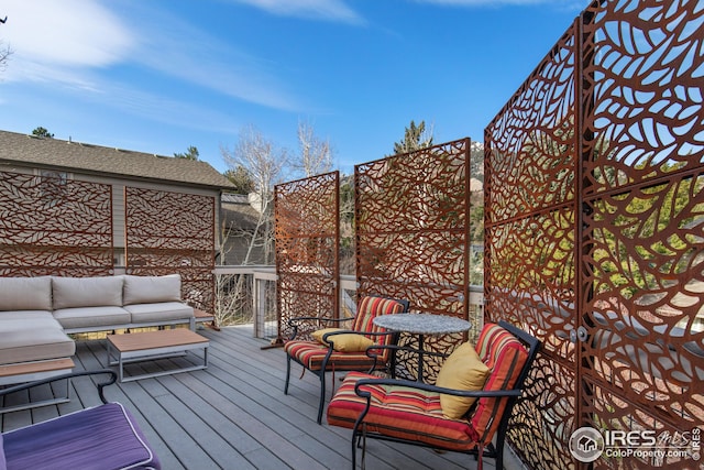 wooden deck with an outdoor living space