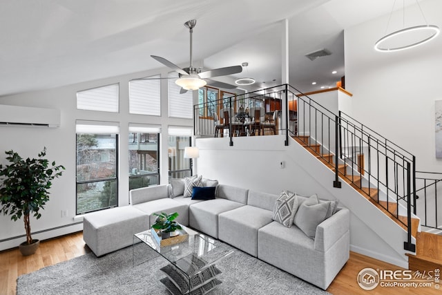 living room featuring high vaulted ceiling, wood finished floors, a wall unit AC, a baseboard radiator, and stairs