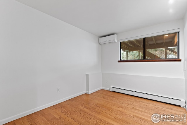 unfurnished room with baseboards, baseboard heating, wood finished floors, and a wall unit AC