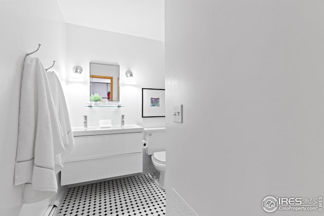 bathroom with tile patterned flooring, toilet, and vanity