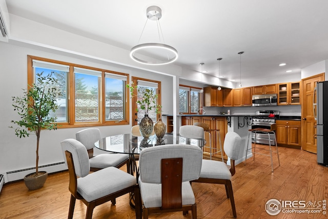 dining space with baseboard heating, recessed lighting, and light wood-style floors