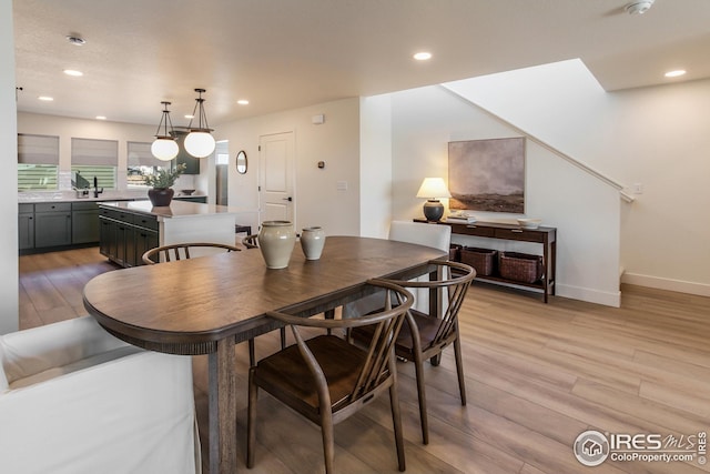 dining area with recessed lighting, baseboards, and light wood-style flooring