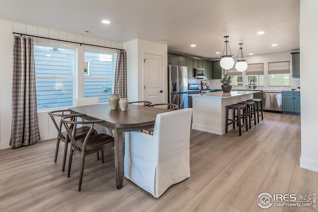 dining area featuring recessed lighting and light wood-style flooring