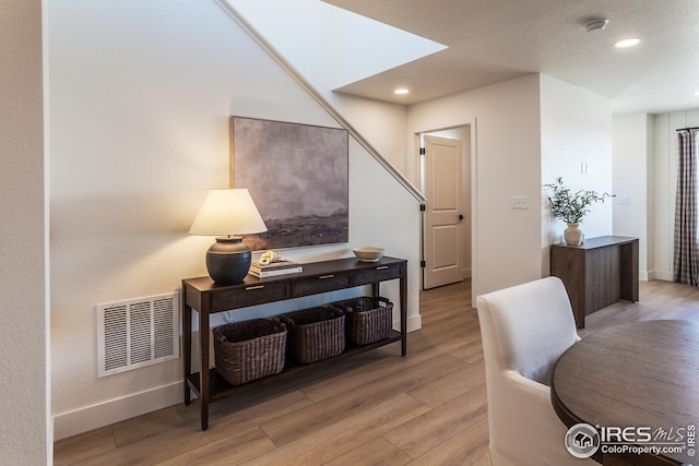 office with visible vents, recessed lighting, baseboards, and light wood-style floors