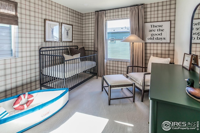 bedroom with carpet flooring and wallpapered walls